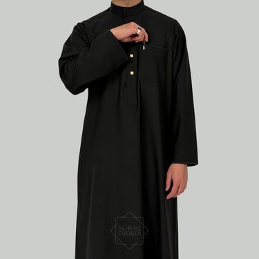 Black straight collared thobe worn by a model on a gray background with 'Al-Haq Thobes' branding.